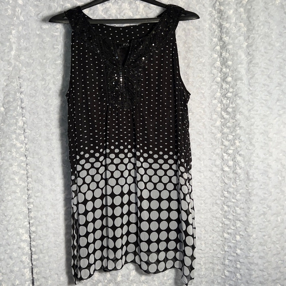 Sequins embellish the chest & neck